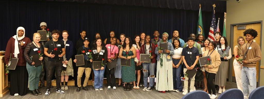 A large group of students gather for a photo in the auditorium